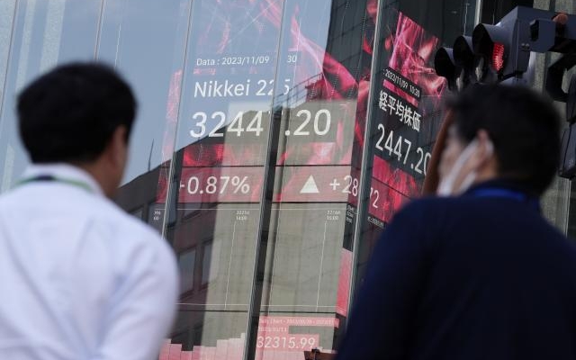 A stock market board featuring Japan's Nikkei 225 index outside a securities firm in Tokyo.
Image Source: The Associated Press